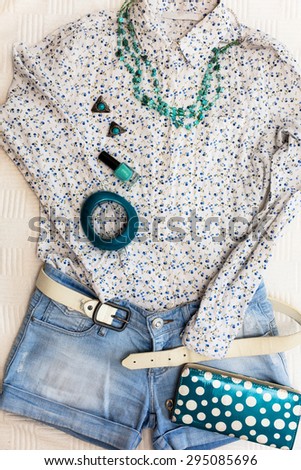 Casual woman outfit. Jeans shorts, shirt and accessories. Top view.