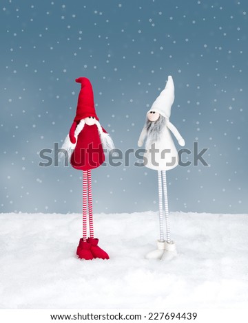 Two christmas elf standing in the snow