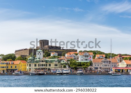 Marstrand, Sweden - July 11, 2015: Part of the community of Marstrand island with its most famous tourist attraction, Carlsten Fortress. It was part of Swedish defense against the Danes at old days.