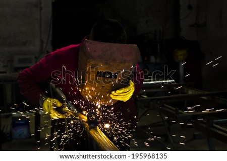 welder working with electrode at semi-automatic arc welding in Stok fotoğraf © 