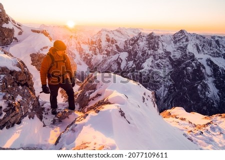 Similar – Image, Stock Photo Traveler contemplating snowy ridge in sunlight