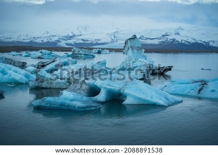 Icebergs floating. Ices and icebergs. Glacier lagoon. Greenland iceberg. Melting ice. South coast Iceland. Jokullsarlon glacier lagoon. Volcanic ash on the ice. Ice age glacier. Melting iceberg