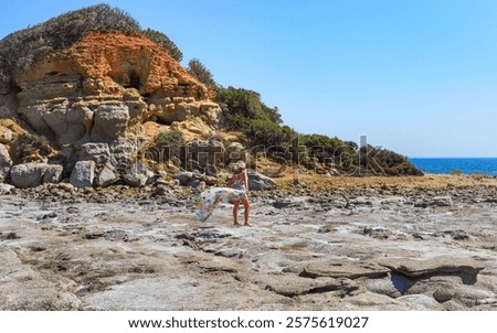Similar – Image, Stock Photo Woman on stony seashore looking on foamy water washing peaks