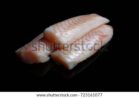 raw white fish fillet on a black background Stock foto © 