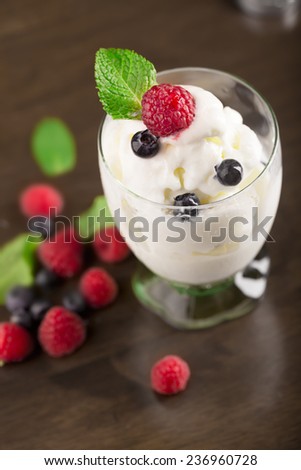 Bowl of delicious melted ice cream with berries