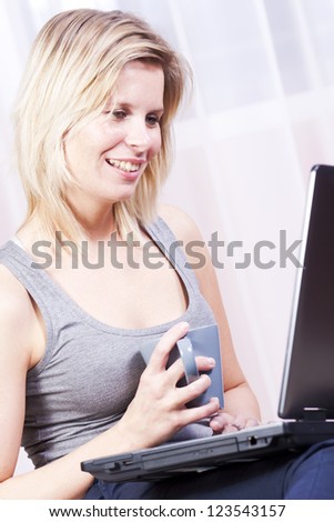 Beautiful blonde woman using a computer.
