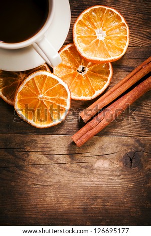 Tastefully presented with a cup of coffee, and orange slices.