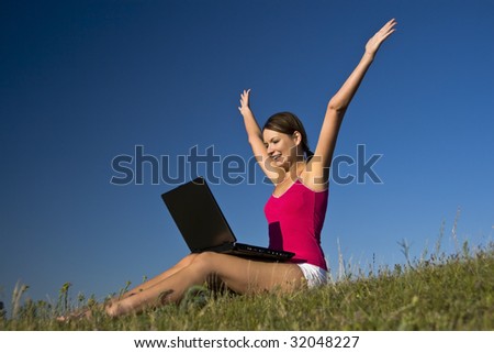 Beautiful young woman using a laptop, and happy.