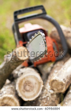 Chain saws cut logs in nature.