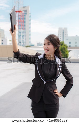 winner woman excited holding tablet pc  Cheerful happy fresh Asian  female model at the building