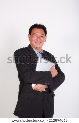 Smiling old man businessman working with laptop. Isolated over white background