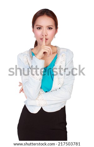 Silence please, attractive businesswoman holds finger on her lips on white background