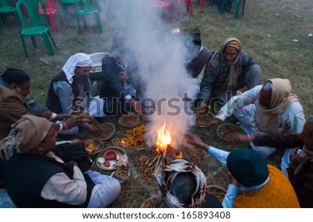 BABUGHAT, KOLKATA, WEST BENGAL / INDIA - 9TH JANUARY 2013 : Hindu devotees lighting a camp fire on 9th January, 2013 in Babughat transit Camp, Kolkata. They are on their way to Gangasagar (Sagar) .