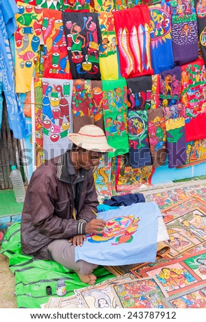 KOLKATA, WEST BENGAL , INDIA - DECEMBER 12TH 2014 : Unidentified artist painting handmade clothes, handicrafts show during Handicraft Fair in Kolkata - the biggest handicrafts fair in Asia.