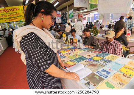 KOLKATA, INDIA - FEBRUARY 5TH : Unknown happy woman buying books at Kolkata book fair, on February 5th, 2015 in Kolkata. It is world\'s largest, most attended and famous non-trade book fair.