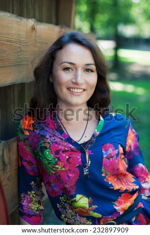 Attractive smiling woman on green background