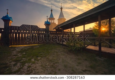 Wooden Church at dawn with the sunlight and rays