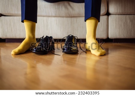 The man wears shoes. Yellow socks.