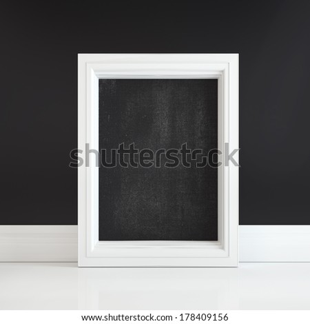 Black board in white frame on a white floor near black wall