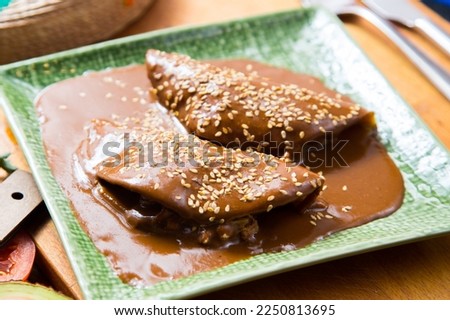 Mexican tacos covered with mole sauce. The term mole refers to various types of highly seasoned Mexican sauces made primarily from chili peppers and spices. Foto stock © 