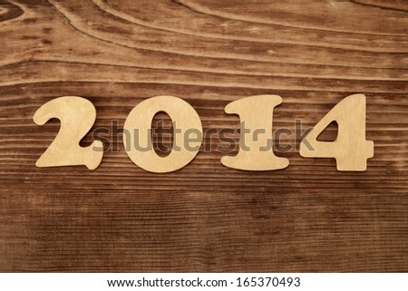 New Year wishes on wooden background.