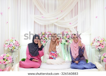 Kuala Lumpur, Malaysia March 22, 2015. Bridesmaid happy and smile face at malay wedding ceremony