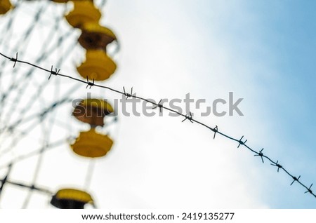 Similar – Image, Stock Photo barbed wire and carousel in amusement park in Chernobyl