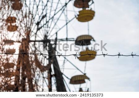 Similar – Image, Stock Photo barbed wire and carousel in amusement park in Chernobyl