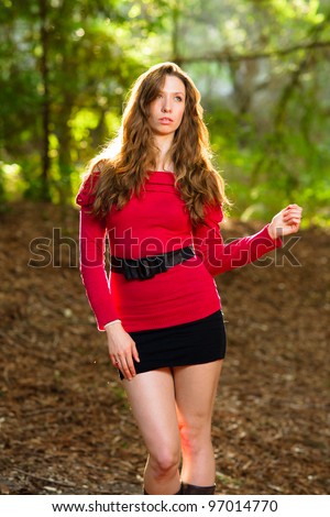 Beautiful woman walking in the park with back-lighting