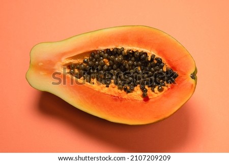 Papaya fruit on a orange background. Tropical fruit. Half papaya.  ストックフォト © 