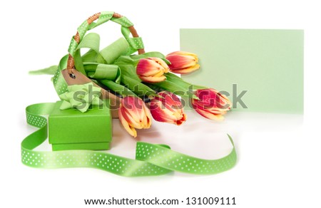 Empty envelope, bunch of tulips and gift box on white background, focus on the envelope