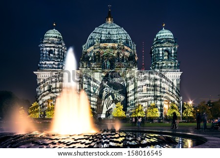 BERLIN, GERMANY - OCTOBER 12: Berliner Dome illuminated during FESTIVAL OF LIGHTS on October 12, 2013  in Berlin, Germany. This colorful show attracts many tourists and residents alike