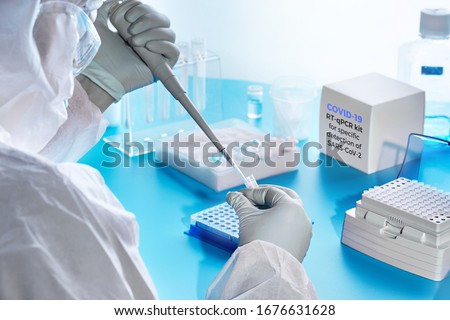 SARS-COV-2 pcr diagnostics kit. Epidemiologist in protective suit, mask and glasses performs pcr tests to detect specific region of SARS-nCoV-2 virus, cause of Covid-19 viral pneumonia. Stok fotoğraf © 