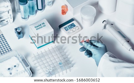 Similar – Image, Stock Photo rt-PCR COVID-19 virus disease diagnostic test,lab technician wearing blue protective gloves holding test tube with swabbing stick,swab sample equipment kit & CDC form specimen submitting guidelines