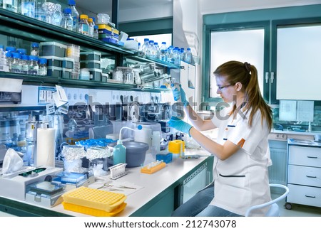 Young scientist works in modern biological lab