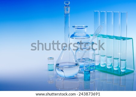 Scientific background with chemical glass, flask and tubes