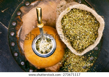 Yerba mate in a traditional calabash gourd and bag of dry herb