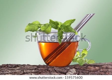 Cup of tea with peppermint and green background