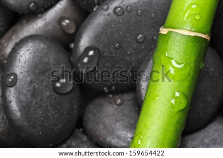 Bamboo and hot stones with water drops