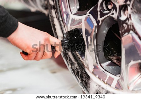 Car cleaning cast silver car rims using a brush Stock fotó © 