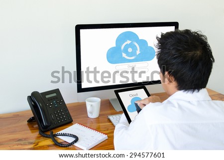 Man use cloud technology on tablet and computer