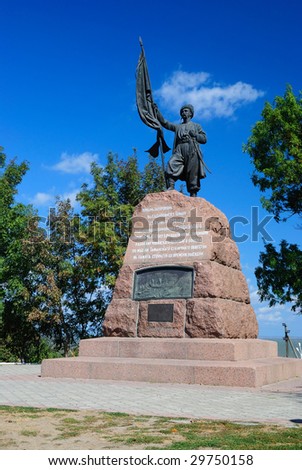Monument to the Cossack with a banner against the sky