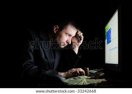 The guy in a jacket with money working on pc