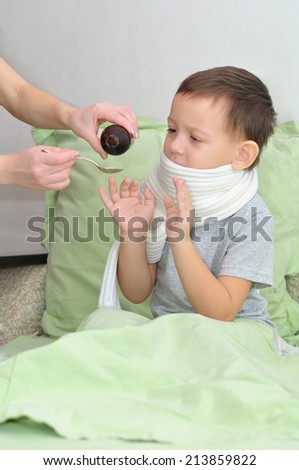 Boy scarf sick but does not want to drink a medicine