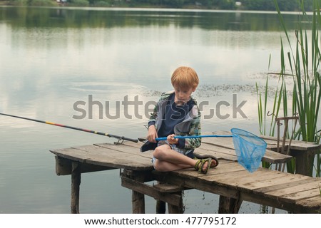 Similar – Image, Stock Photo child holding a fish and showing it to the camera