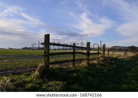 Old wooden fence outside of Northwestern English farmland in Wigan, England.