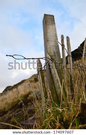 Wooden fence post near the peak of Arthur's seat in Edinburgh, Scotland.