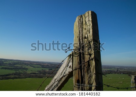 The old wooden fence overlooking the green English fields below in Parbold, England.