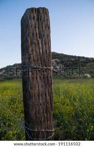 The old barbed wire fence with hills in the background on a Southern Californian sunset.
