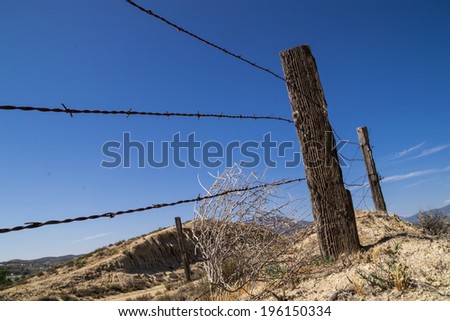 The old barbed wire fence in the California desert.